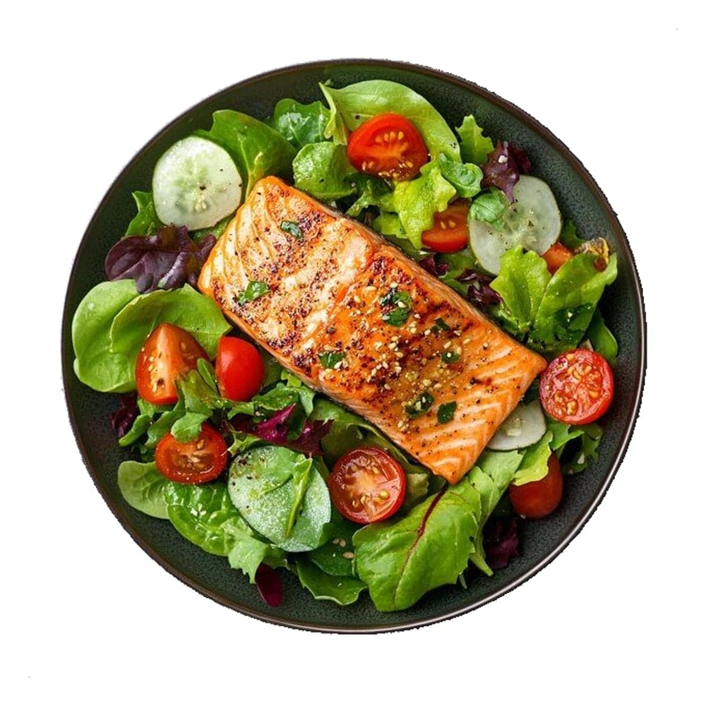 Grilled salmon fillet on mixed salad with cucumber, cherry tomatoes and lime